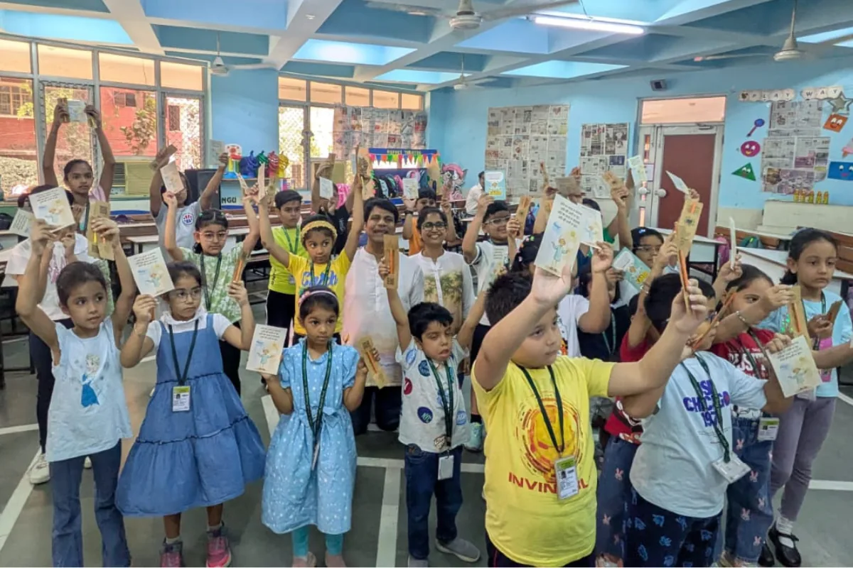 Children holding up doha cards during a Kabir for Kids school workshop at Delhi Public School, Vasant Kunj, May 2026