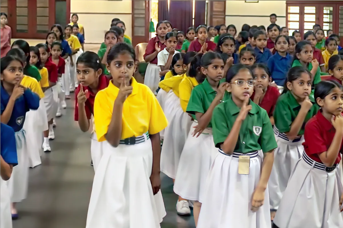 Children at St Mary's Convent, Allahabad, standing in formation with hands folded in namaste during a K4K session, April 2026