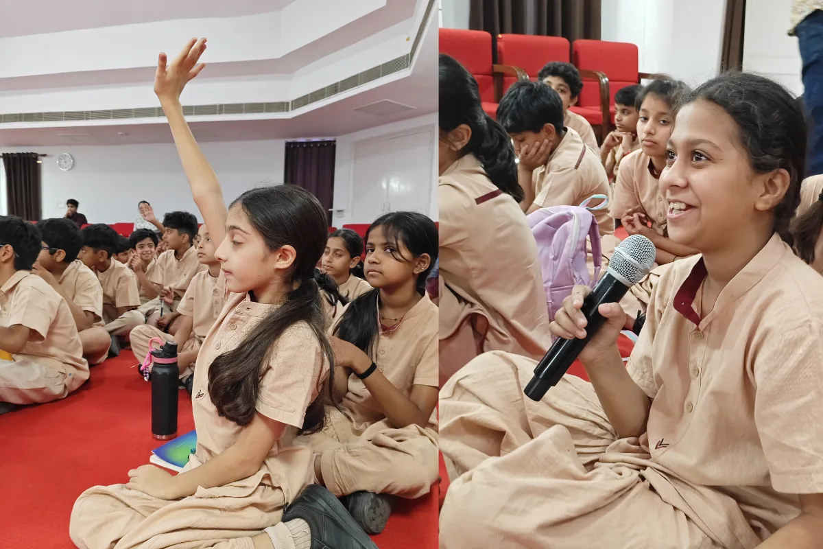 A girl with a microphone answering a question during a K4K session at NBT Vasant Kunj